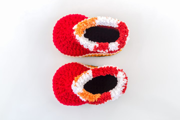 Little baby shoes. Kids knitted shoe handicraft.