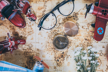 Fototapeta na wymiar Go on an adventure, Overhead view of Traveler's accessories, Essential vacation items, Travel concept background, vintage background, love story, selective focus, go to see the world