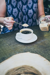 cup of coffee on old wooden desk. Simple workspace or coffee break in morning/ selective focus