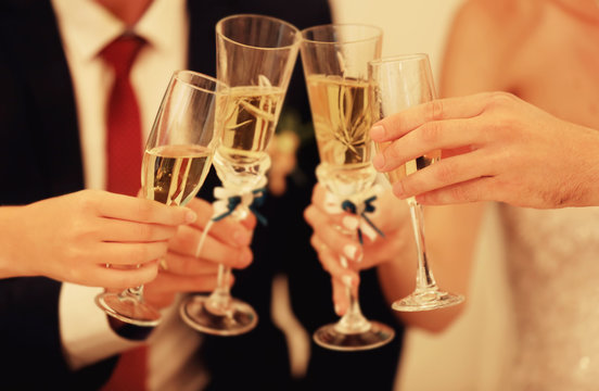 Hands with champagne glasses on wedding dinner