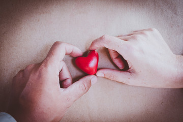 hand holding a red heart, valentine's day love, vintage tone