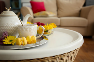 Tea set with cookies on modern sofa background