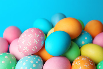 Fototapeta na wymiar Colorful Easter eggs on blue background, closeup