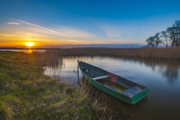 fishing boats on the lake during sunset, lake Miedwie, Poland