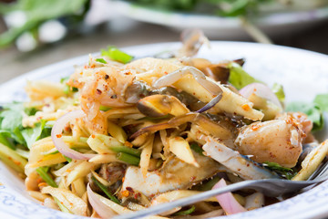Fresh crab spicy mango salad on white plate.