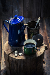 Aromatic and hot black coffee on wooden stump