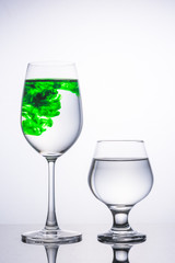 Wine glass There are two color green white , isolated on gray ba