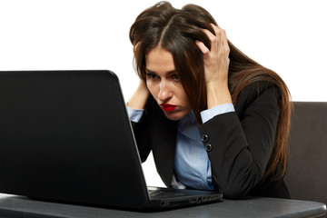 Frustrated young businesswoman at her laptop