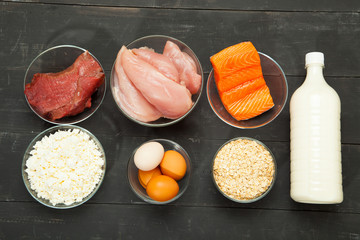 Proteins, fish, cheese, eggs, meat and chicken on a black background - 132006643