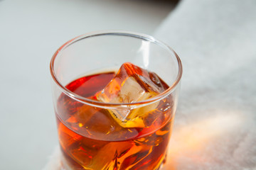 Whiskey with ice on a winter background