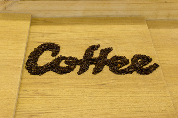 coffee text make from coffee bean on wooden background