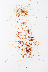 Red hot chili pepper's flakes. White background. isolated.