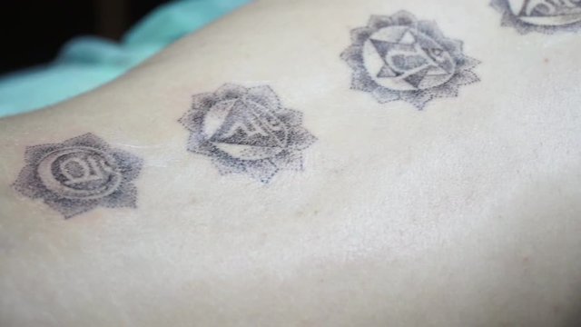 Slow motion, close-up of a tattoo style dotwork spine, slidecam