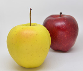 Red yellow apple with green leaf and slice isolated on white background