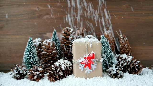 Christmas and New Year background with snow, pine cones, present with red fir tree.