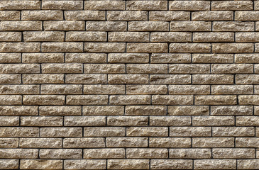 Brick wall textured/Wall made of decorative yellow brick as a texture and background.