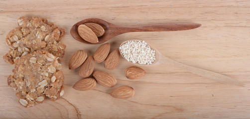 Almonds and Sesame seeds on the wooden floor