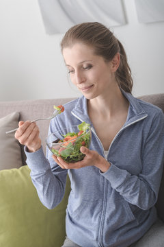 Young woman having lunch at home