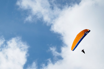 Paragliding over cloudy sky background -0