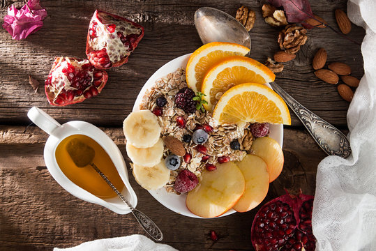 Healthy breakfast. Muesli with orange fruit, apple, pomegranate,