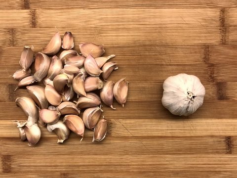 Garlic and clove of Garlic on a old rough wood table from above