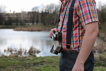 beard man with retro camera in the park