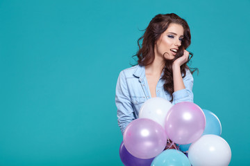Fototapeta na wymiar Young pretty woman with colored balloons