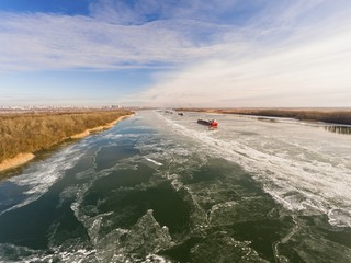 Cargo ship in beautiful frozen river. Stock image.