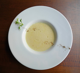 Mushroom soup in white plate top view