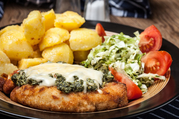 Fried chicken fillet with spinach and cheese.