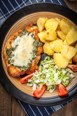 Fried chicken fillet with spinach and cheese.