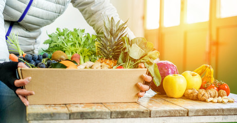 Fruit seller woman with different fruits and vegetables in shop