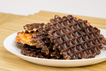 Cookies and chocolate on the mat of bamboo