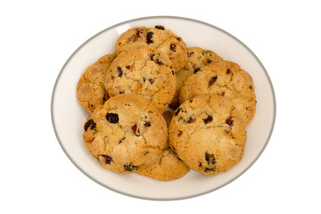 Cookies with raisins on a white plate. Top view