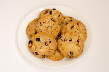 Cookies with raisins on a white plate. Top view