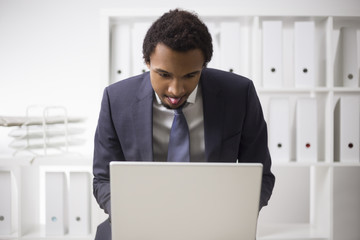 African businessman working with tongue out