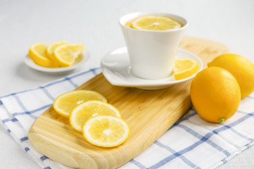 Lemons and tea on a light background