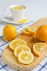 Lemons and tea on a light background