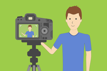 Fototapeta premium Studio blog recording on chroma key background. Vlog. Video recording. Handsome boy.