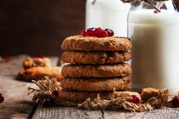 Milk beverages in glass bottles, crisp cookies with pomegranate