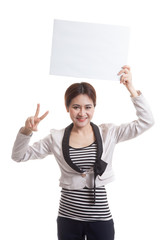 Young Asian business woman show victory sign with blank sign.