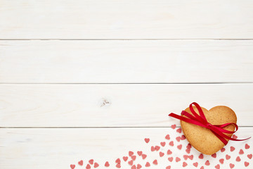 Fototapeta na wymiar Ginger cookies on white wooden background with little candy hearts