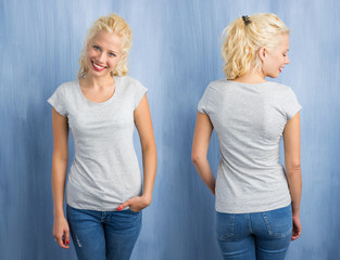 Woman in grey round neck T-shirt on blue background