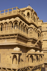 Fototapeta premium Intricately carved walls and balconies of the honey coloured Jaisalmer Palace in Jaisalmer Fort in Rajasthan, India. 17th century Rajput architecture. 