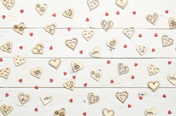 Texture of different shape heart figures on white wooden background 