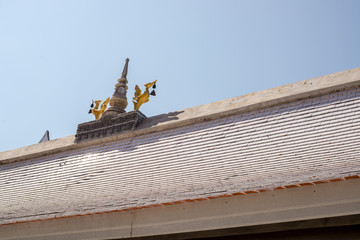 Gold swan lamp on the roof of temple