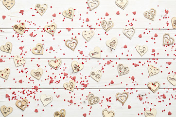 Texture of different shape heart figures on white wooden background 