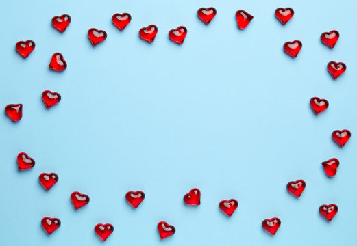 Plain blue background with frame made of little, red hearts
