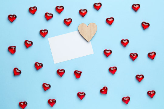 Plain blue background with frame made of little, red hearts and white message inside of it