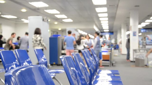 Defocus or Blur of Passenger ( Man and Woman ) Scan Body and Luggage at Airport Security Check for pass to Boarding Gate with Blue Seat.